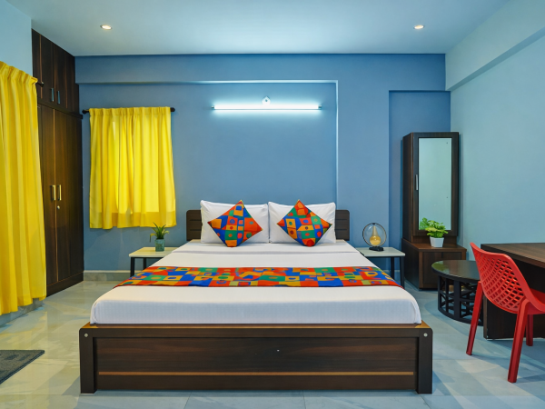 Budget hotel room in AECS Layout Brookefield with king bed, work desk, free Wi-Fi and bright interiors