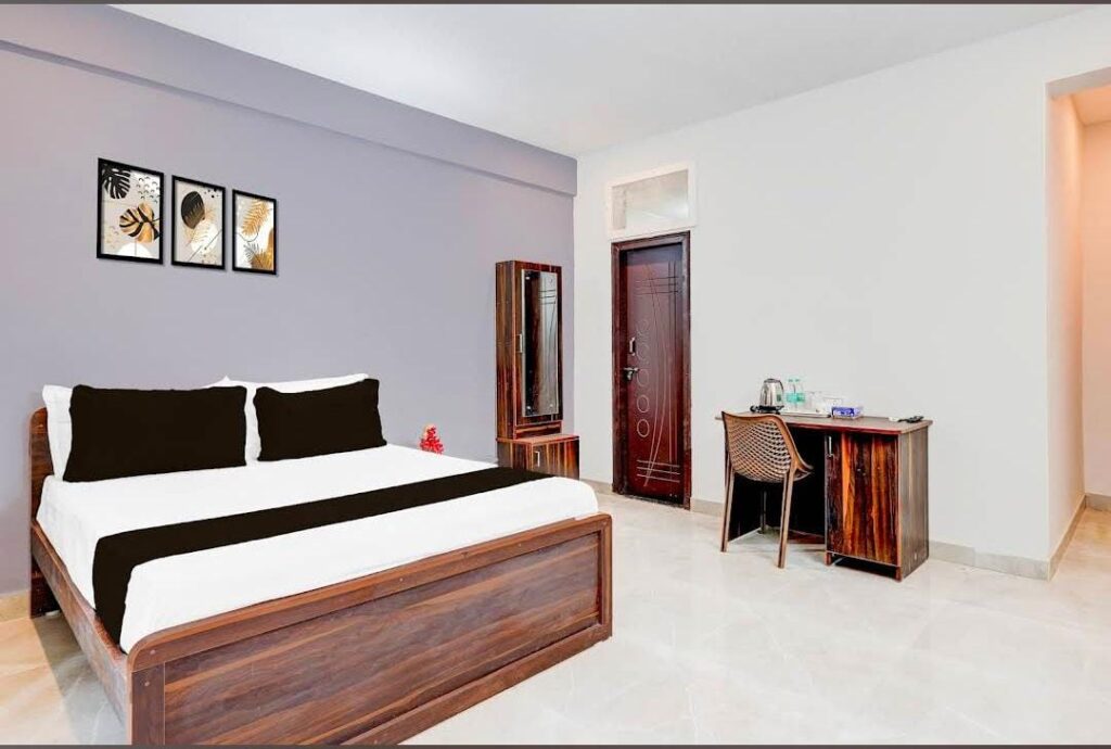 Deluxe double room with wooden bed and clean interiors at JG Residency, AECS Layout Brookefield