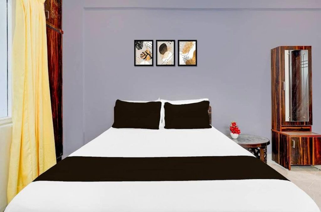 Twin bed hotel room with clean linen and calm lighting at JG Residency Brookefield