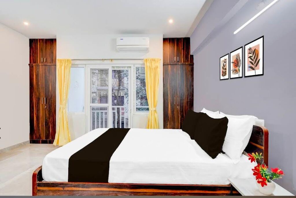 Deluxe double room with wooden bed and clean interiors at JG Residency, AECS Layout Brookefield