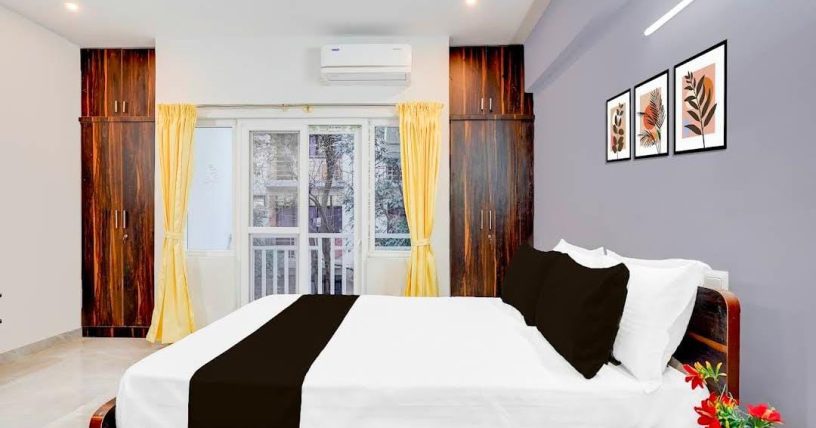 Deluxe double room with wooden bed and clean interiors at JG Residency, AECS Layout Brookefield