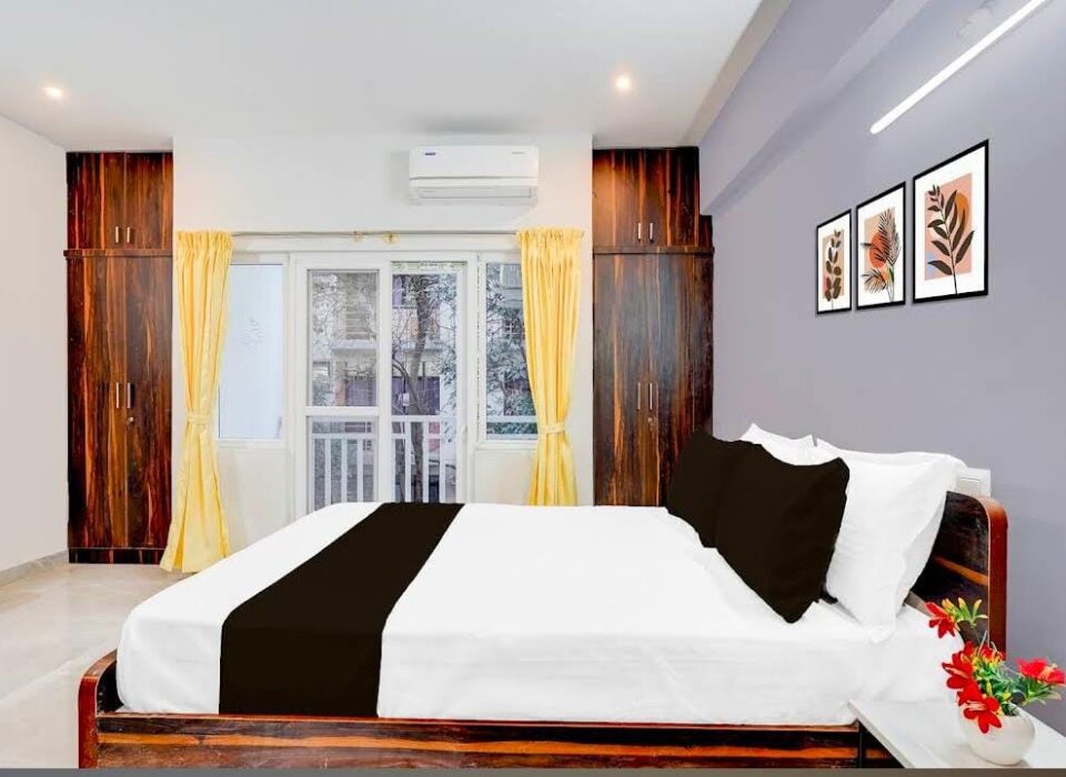Deluxe double room with wooden bed and clean interiors at JG Residency, AECS Layout Brookefield